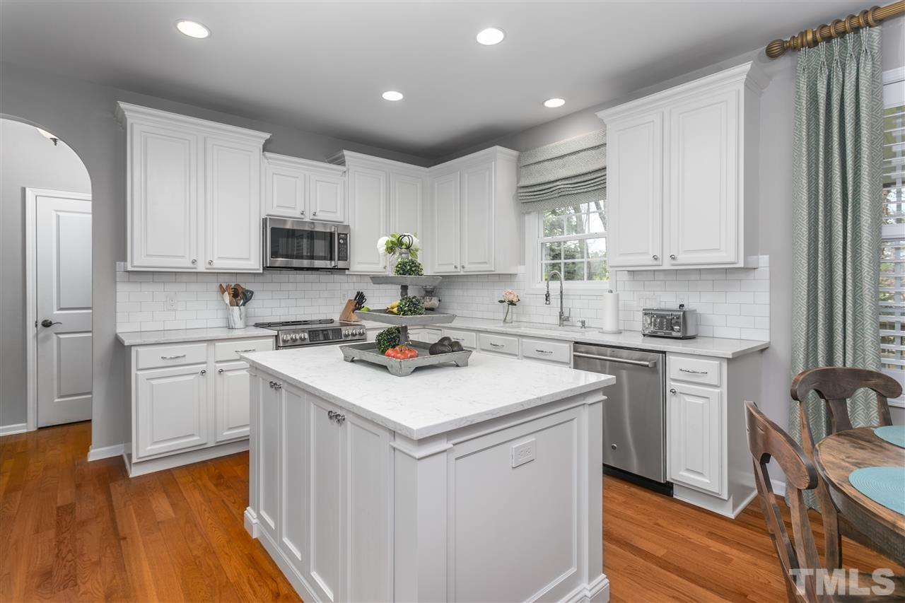 8617 Churchdown Court Raleigh, NC 27613 - Photo 8 of 30 a kitchen with a sink cabinets and wooden floor