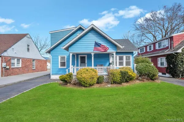 a front view of a house with a yard and porch