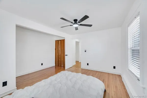 a view of a room with an empty space and a ceiling fan