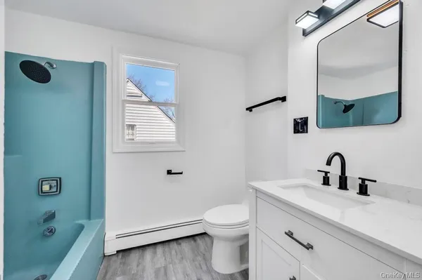 a bathroom with a toilet a sink and mirror