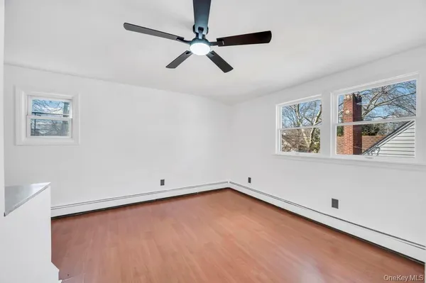 a view of room with window and ceiling fan