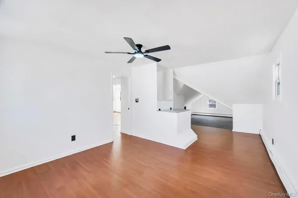 a view of an empty room with a ceiling fan