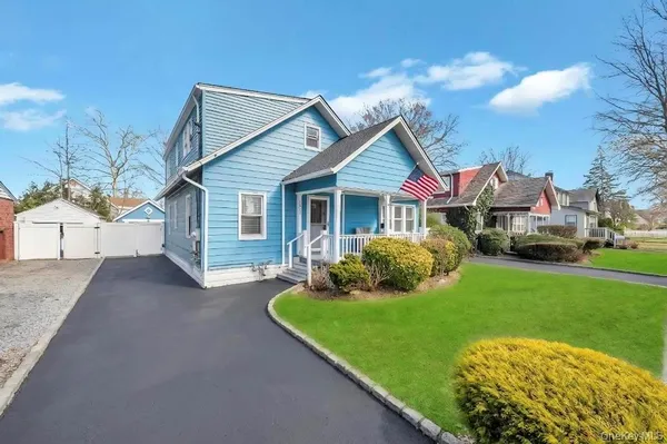 a front view of house with yard and green space
