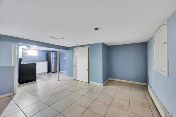 a view of a hallway with wooden floor and cabinet