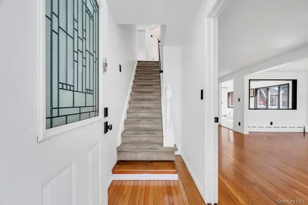 a view of a hallway with wooden floor and staircase