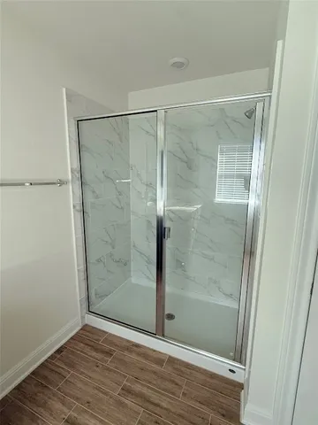 a bathroom with a glass shower door