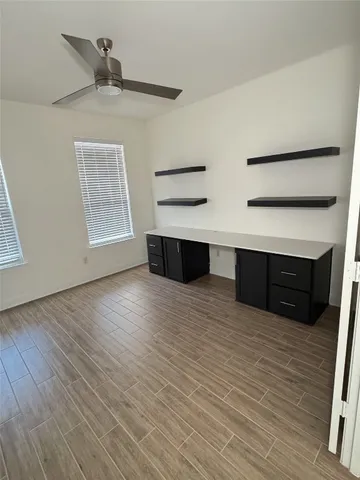 a view of room with wooden floor and cabinet
