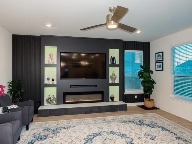 a living room with furniture and a wooden floor