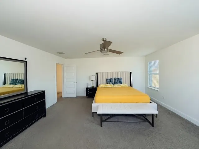 a bed room with a bed and paintings on the wall