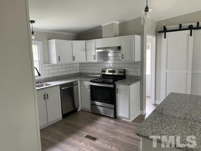 860 Thanksgiving Fire Road Selma, NC 27576 - Photo 11 of 23 a kitchen with a stove and a refrigerator