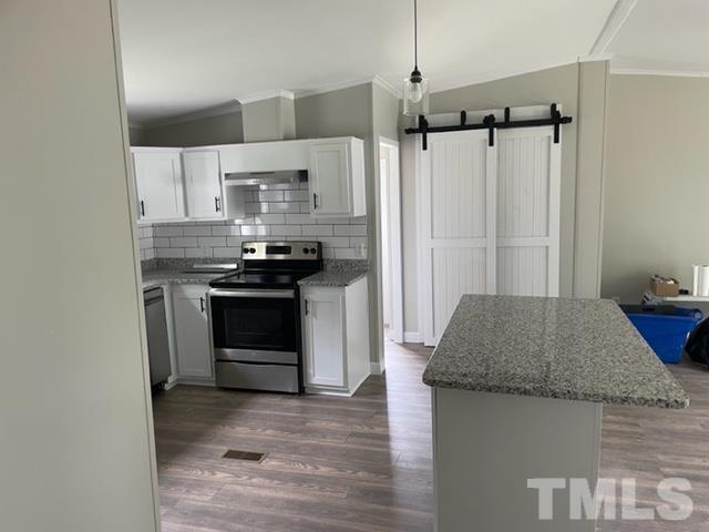 860 Thanksgiving Fire Road Selma, NC 27576 - Photo 12 of 23 a kitchen with kitchen island granite countertop a sink stove and refrigerator