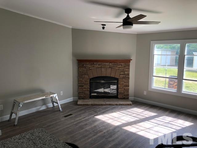 860 Thanksgiving Fire Road Selma, NC 27576 - Photo 15 of 23 a living room with furniture and a fireplace