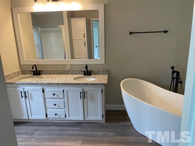 860 Thanksgiving Fire Road Selma, NC 27576 - Photo 18 of 23 a bathroom with a granite countertop tub sink and mirror