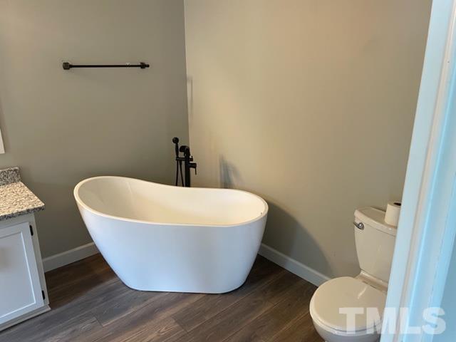 860 Thanksgiving Fire Road Selma, NC 27576 - Photo 19 of 23 a white bath tub sitting next to a toilet