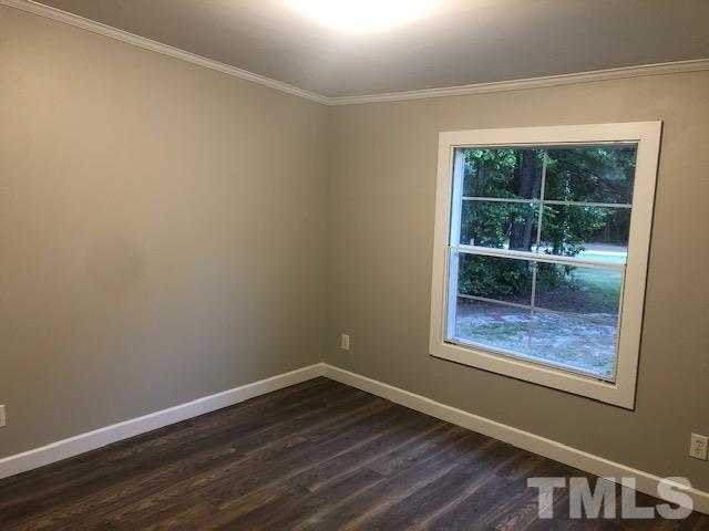 860 Thanksgiving Fire Road Selma, NC 27576 - Photo 20 of 23 a view of empty room with wooden floor and fan