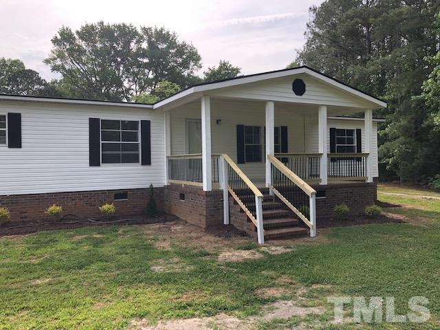 860 Thanksgiving Fire Road Selma, NC 27576 - Photo 2 of 23 a house that has sitting area in front of it