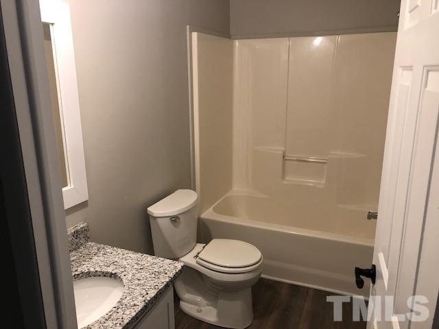 860 Thanksgiving Fire Road Selma, NC 27576 - Photo 22 of 23 a white toilet sitting next to a bath tub