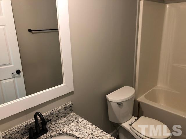 860 Thanksgiving Fire Road Selma, NC 27576 - Photo 23 of 23 a bathroom with a toilet and a shower curtain