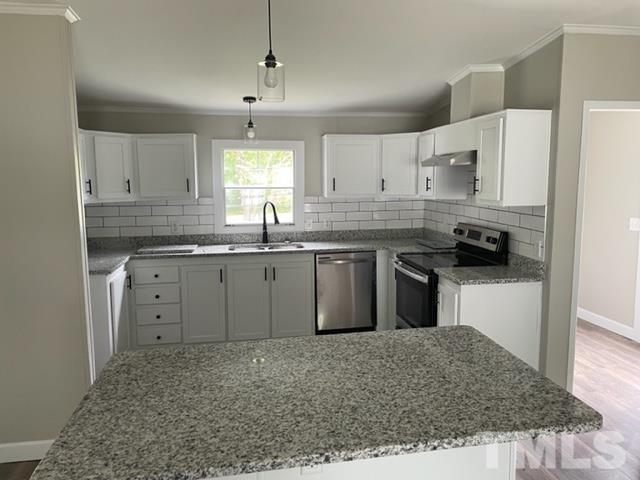 860 Thanksgiving Fire Road Selma, NC 27576 - Photo 10 of 23 a kitchen with stainless steel appliances granite countertop a sink stove and refrigerator