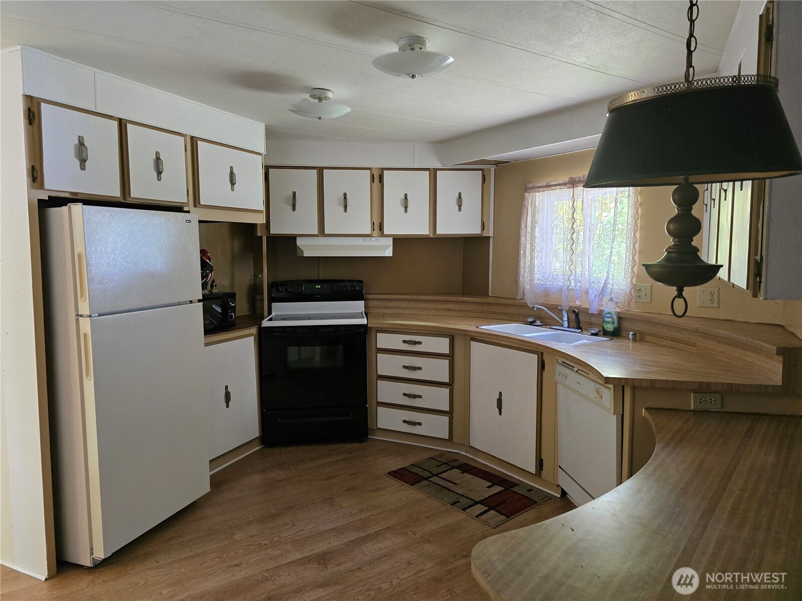 147-21 Morris Road, Unit 21 Randle, WA 98377 - Photo 14 of 31 a kitchen with a refrigerator stove and sink