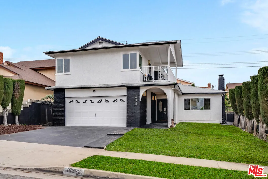19322 Nestor Avenue Carson, CA 90746 - Photo 1 of 1 a front view of a house with a yard and garage