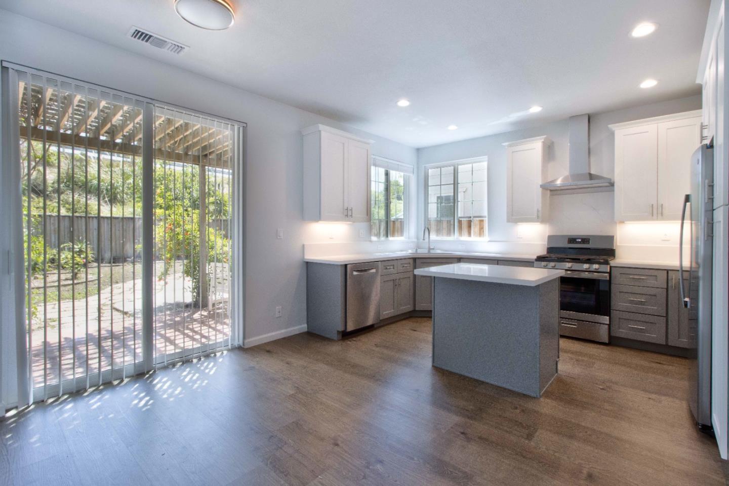 2715 Shellgate Circle Hayward, CA 94545 - Photo 10 of 47 a kitchen with stainless steel appliances granite countertop a stove a sink a refrigerator and white cabinets with wooden floor