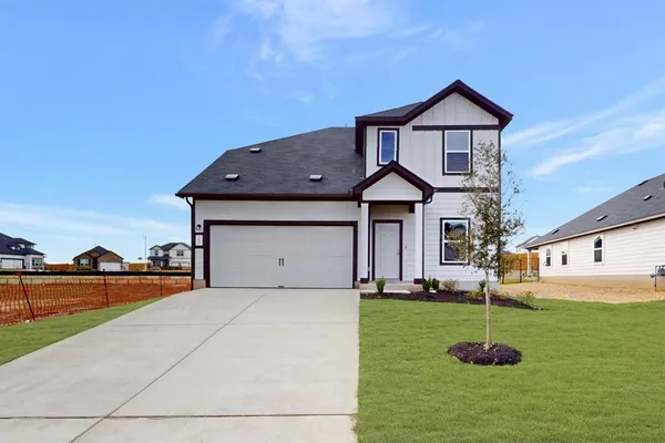 a front view of a house with a yard