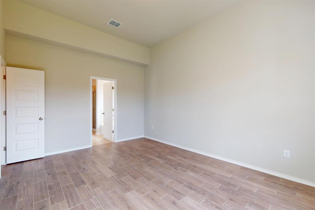 4509 Beacon Bay Drive Austin, TX 78747 - Photo 10 of 30 Unfurnished bedroom with wood finish floors and baseboards