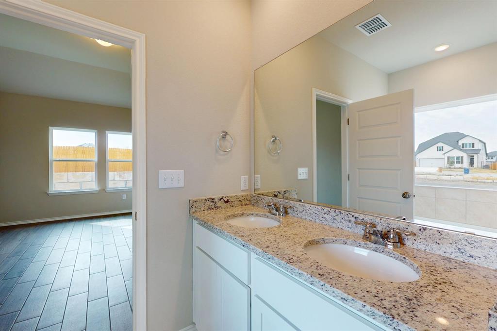 4509 Beacon Bay Drive Austin, TX 78747 - Photo 11 of 30 Full bathroom with double vanity and wood finish floors