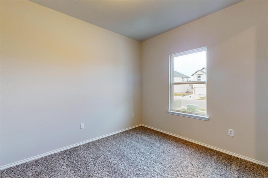 4509 Beacon Bay Drive Austin, TX 78747 - Photo 15 of 30 Carpeted spare room featuring baseboards