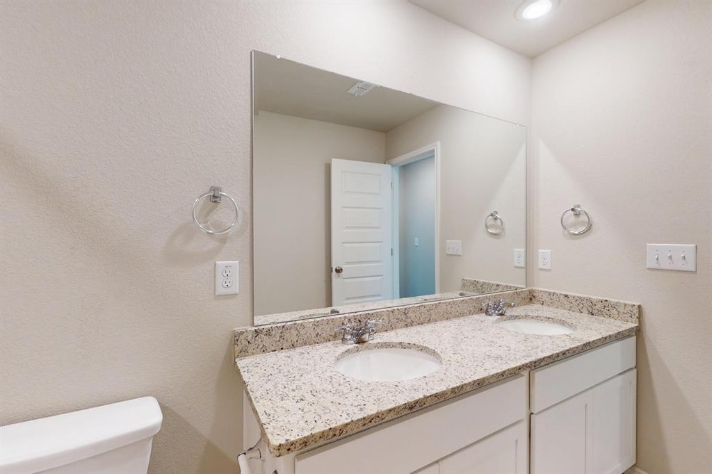 4509 Beacon Bay Drive Austin, TX 78747 - Photo 20 of 30 Full bath featuring double vanity and a textured wall