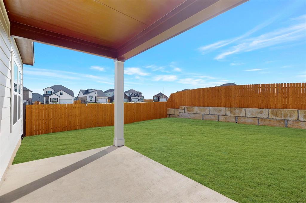 4509 Beacon Bay Drive Austin, TX 78747 - Photo 21 of 30 Fenced backyard with a patio and a residential view