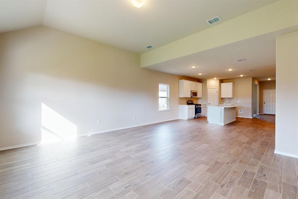 4509 Beacon Bay Drive Austin, TX 78747 - Photo 5 of 30 Unfurnished living room with wood tiled floors and recessed lighting