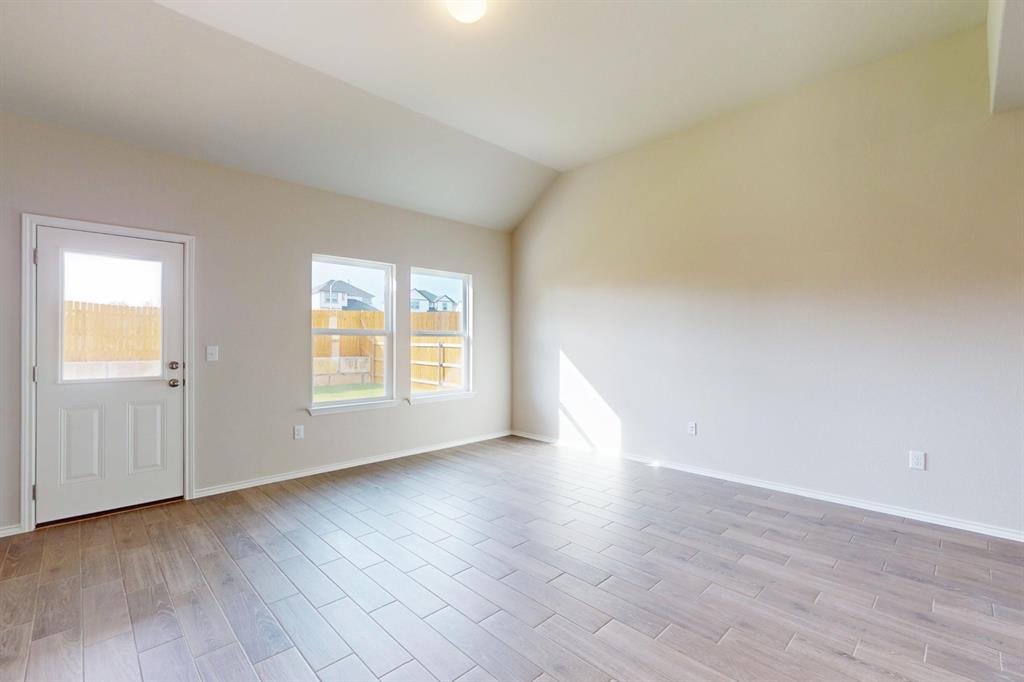 4509 Beacon Bay Drive Austin, TX 78747 - Photo 7 of 30 Spare room featuring wood tiled floors and lofted ceiling