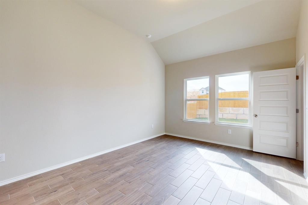 4509 Beacon Bay Drive Austin, TX 78747 - Photo 8 of 30 Spare room with wood finish floors and vaulted ceiling
