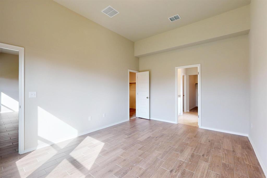 4509 Beacon Bay Drive Austin, TX 78747 - Photo 9 of 30 Unfurnished bedroom with wood tiled floors and baseboards