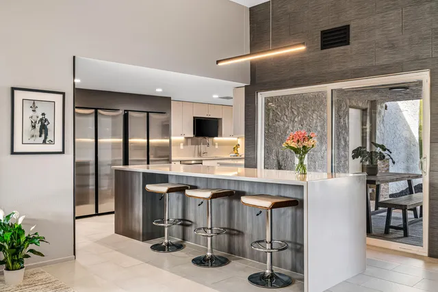 a living room with furniture and a floor to ceiling window