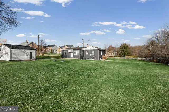 a view of yard with swimming pool and green space