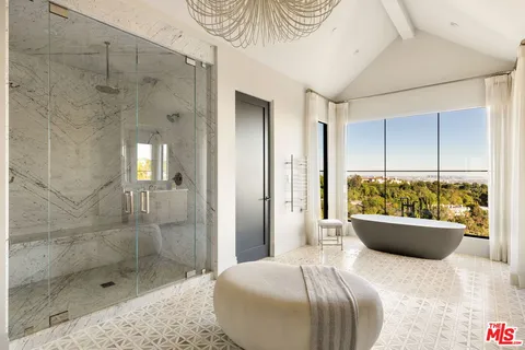 a spacious bedroom with a bed and a window