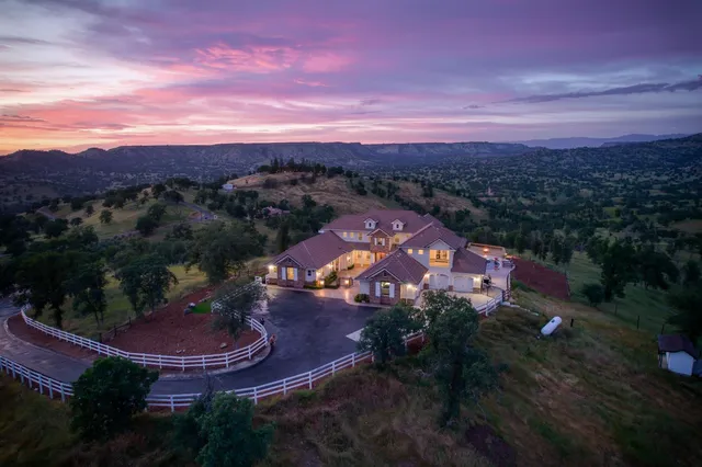 an aerial view of a house with a lake view