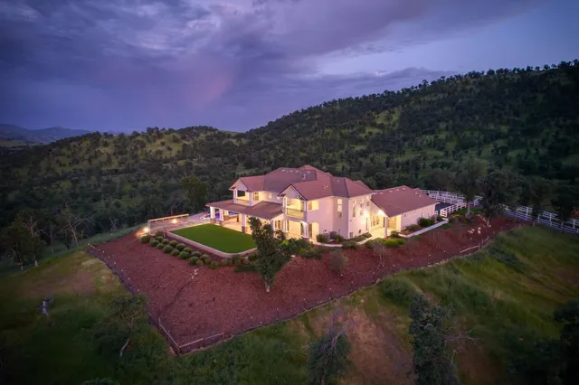 a view of a pathway with a wrought wooden fence
