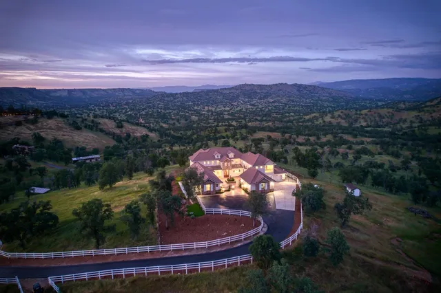 a living room with furniture large window and a fireplace