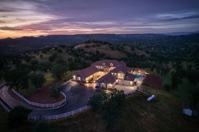 a living room with furniture fireplace and a large window
