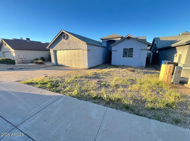 a view of an house with backyard space and garden