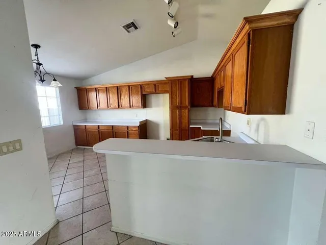 a living room with a couch and a dresser with wooden floor
