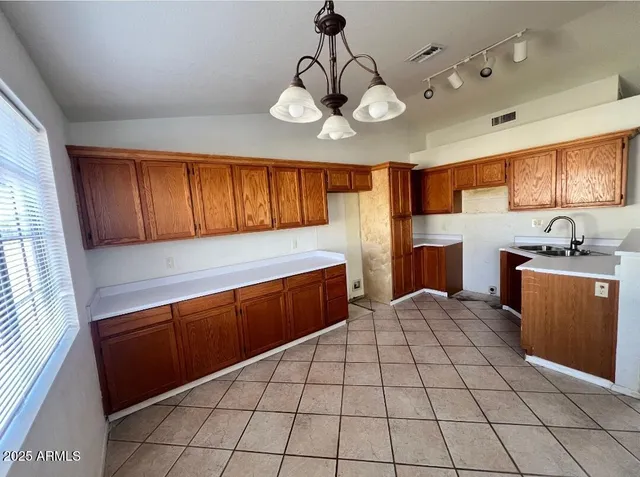 a kitchen with stainless steel appliances granite countertop a sink and cabinets