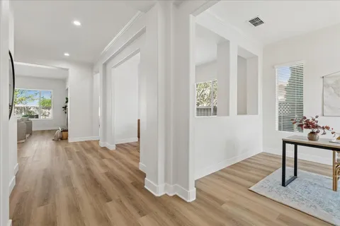 a view of a livingroom with wooden floor and furniture