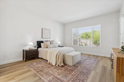 a bedroom with a bed and a couch