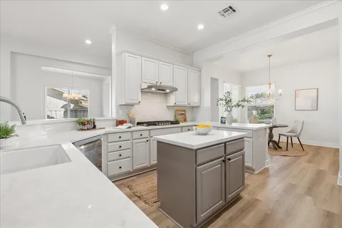a kitchen with a sink stove and cabinets