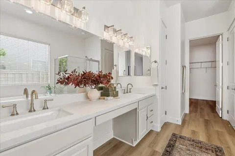a bathroom with a double vanity sink and a mirror